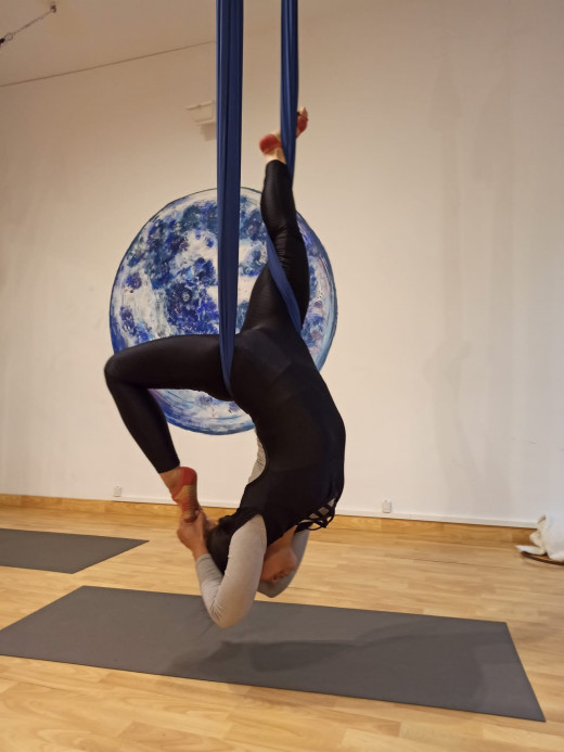 A picture of me doing aerial yoga at Let's Fly Barcelona.