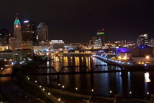 The skyline of Columbus on the Scioto River, lit up in December, City Hall in the center.