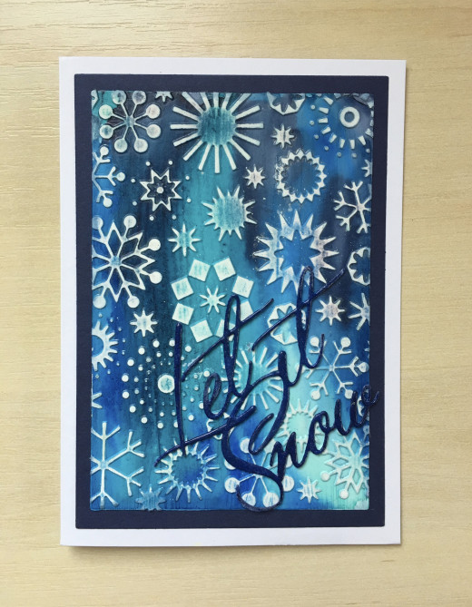 Really love this technique: Paint gesso over the paper, then add alcohol inks, then use an embossing folder. Sand the raised area. I heat embossed the sentiment with several layers..
