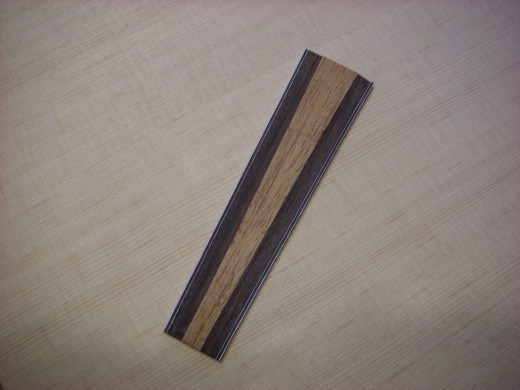 This is rosewood binding with white/black/white and a piece of scrap mahogany that came in the kit.  The mahogany is cut at 2 degrees on each side.