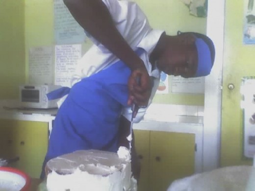 Male Food and Nutrition Student Decorating Cake