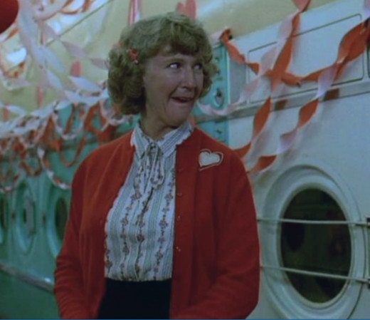 Mabel (Patricia Hamilton) gets excited after she receives a box of chocolates from a secret admirer