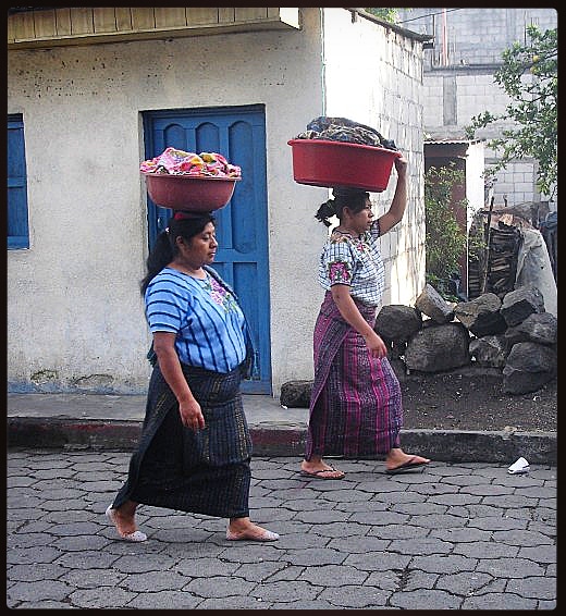Women carrying their laundry back from the lake