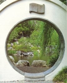A moon gate frames a view of the lake.