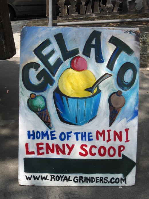 Sign for Gelato being sold behind the statue