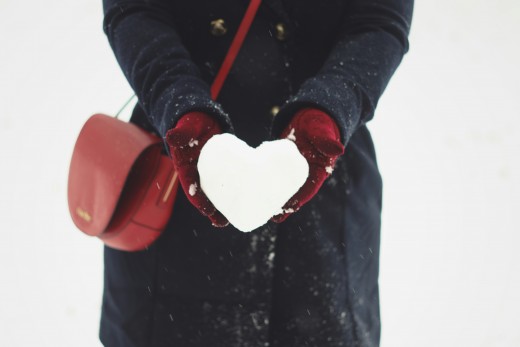 Person holding heart-shaped snow, photo by Iga Palacz on Unsplash