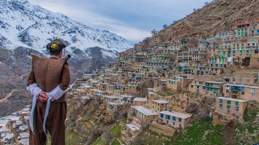 A Hawrami man in Hawrami clothes looks at his village