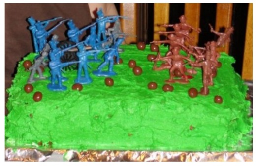 This is probably the easiest option.  Add some green food coloring to vanilla frosting.  Top the cake with army men.  My oldest son decorated this.  He added peanut butter ball "cannon balls" and red icing "blood."