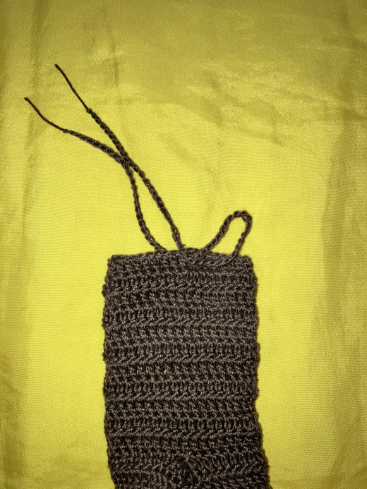Put the folded side into the hole left at the top of the yoke - push from the inside to the outside.