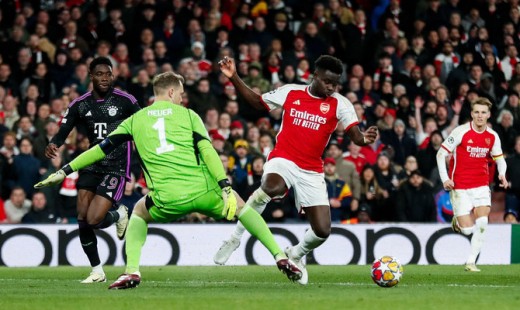 Bayern Munich’s goalkeeper Manuel Neuer challenges Arsenal’s midfielder Bukayo Saka during the first leg of the UEFA Champions League quarter-final at the Emirates Stadium in north London on April 9, 2024 