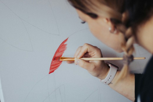 A female painting, photo by Lukas Hellebrand on Unsplash