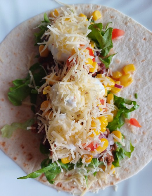Topped with Greek yogurt and grated mild cheddar cheese or similar