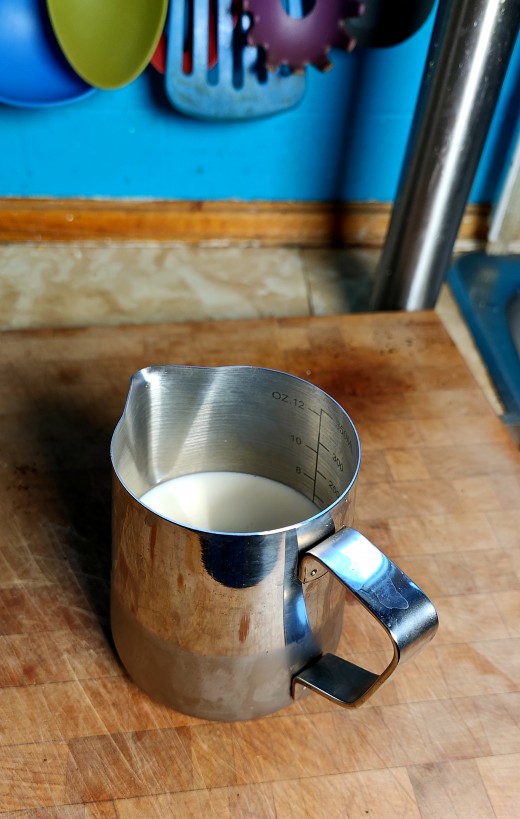 A half-jug of milk before being frothed