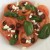 Sliced tomato, black olives, feta and basil