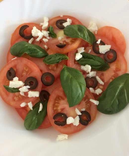 Sliced tomato, black olives, feta and basil