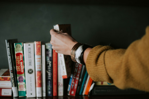 Person picking a book off the shelf, photo by Christin Hume on Unsplash Person picking a book off the shelf, photo by Christin Hume on Unsplash
