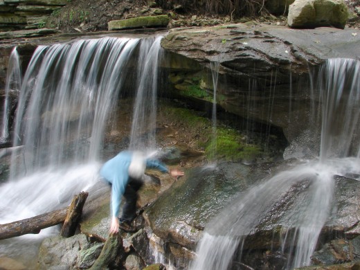 Joe Hollick trying to go behind Lower Tews Falls before the timer on the camera takes the photo. Rocks too slippery to get there before the self timer went off.