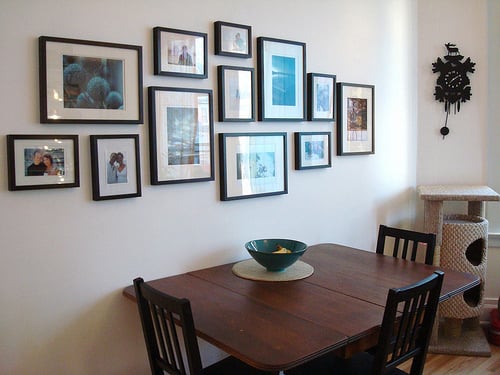Using photographs for wall décor can create a homely atmosphere.