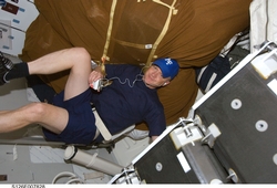 Astronaut Boe exercises on the shuttle middeck.