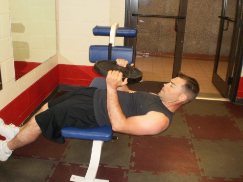 The Roman Chair Weighted Sit-up start position