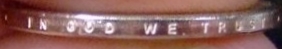 The inscription "In God We Trust" can be found on the edge of pre-2009 Coins, and on the face of coins minted thereafter.