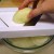 Using a mandolin to cut the potato Using a mandolin to cut the potato