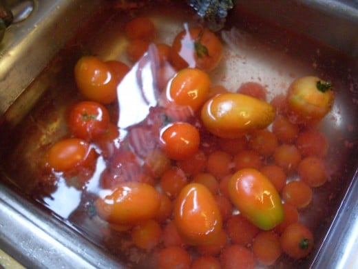 Immediately place tomatoes in cold water (ice is good). Leave in cold water at least as long as they were in the boiling water.