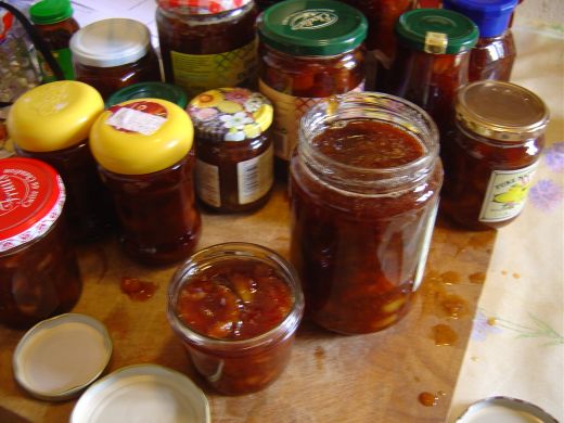 I use old jars, thoroughly washed and sterilised in the microwave. I find this a messy procedure, as you can see in this photo.