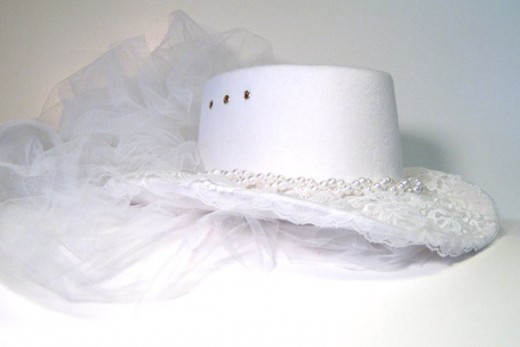 White Western style wedding hat goes well with the Victorian lace dress and Victorian leather and lace boots