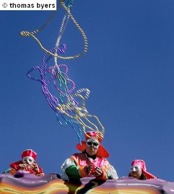 Krewe Members Throwing Beads From A Float
