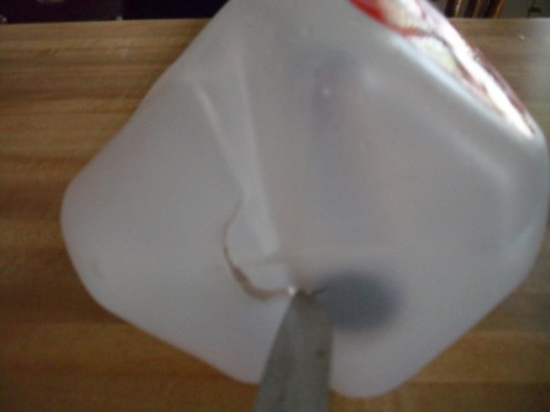 A seam in the bottom of the bottle would not allow the pole to rest level. I cut a hole in the center of the bottom of the base bottle so the pole could rest level in the hole.