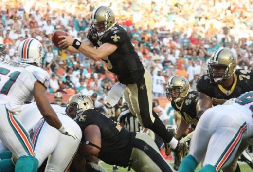 New Orleans quarterback Drew Brees (9) goes over his linesmen to score a touchdown from within the one yard line Sunday, Oct. 25, 2009 in Miami as they play the Miami Dolphins. (AP Photo/J Pat Carter)