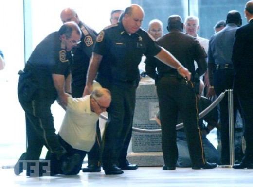 Moore's refusal to remove the commandments encourages other Americans to stand for the acknowledgment of God in public places. Here, a man who is trying to stop the removal of the monument is dragged away.