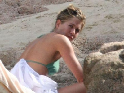 Jennifer Aniston relaxing at the beach in a green bikini