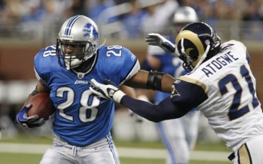 St. Louis Rams safety Oshiomogho Atogwe (21) stops Detroit Lions running back Maurice Morris (28) during the second quarter of an NFL football game at Ford Field in Detroit, Sunday, Nov. 1, 2009. (AP Photo/Carlos Osorio)