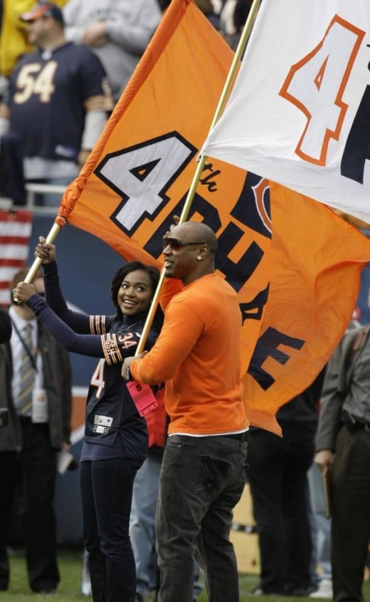 Jarrett and Brittney Payton, son and daughter of former Chicago Bears great Walter Payton, wave giant flags during pregame ceremonies before an an NFL football game between the Bears and Cleveland Browns in Chicago, Sunday, Nov. 1, 2009. The game was