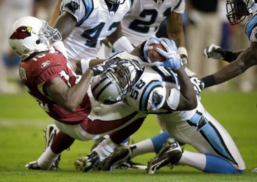 Carolina Panthers linebacker Thomas Davis (58) intercepts a pass intended for Arizona Cardinals wide receiver Steve Breaston (15) during the first half of an NFL football game Sunday, Nov. 1, 2009, in Glendale, Ariz. (AP Photo/Paul Connors)