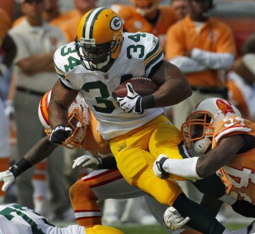 Green Bay Packers running back Ahman Green (34) is pulled down by Tampa Bay Buccaneers linebacker Geno Hayes (54) during the first quarter of an NFL football game Sunday, Nov. 8, 2009, in Tampa, Fla. (AP Photo/Chris O'Meara)