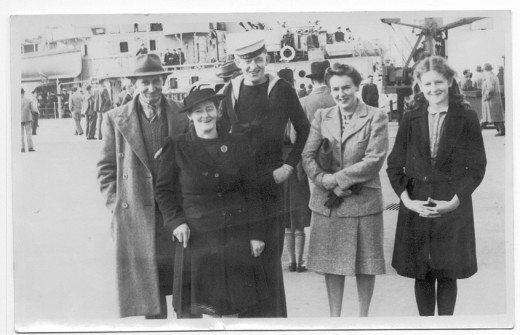 This is a family photo so I know the story. Mum and Dad, little sister and girlfriend are seeing son off to sea in the Navy.