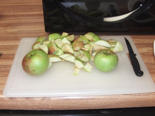 Use a chopping board to cut up the organic homegrown apples.