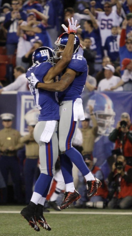 New York Giants wide receiver Steve Smith (12) celebrates with fellow receiver Domenik Hixon (87) after catching a pass for a touchdown against the San Diego Chargers in the second quarter of an NFL football game, Sunday, Nov. 8, 2009, in East Ruther