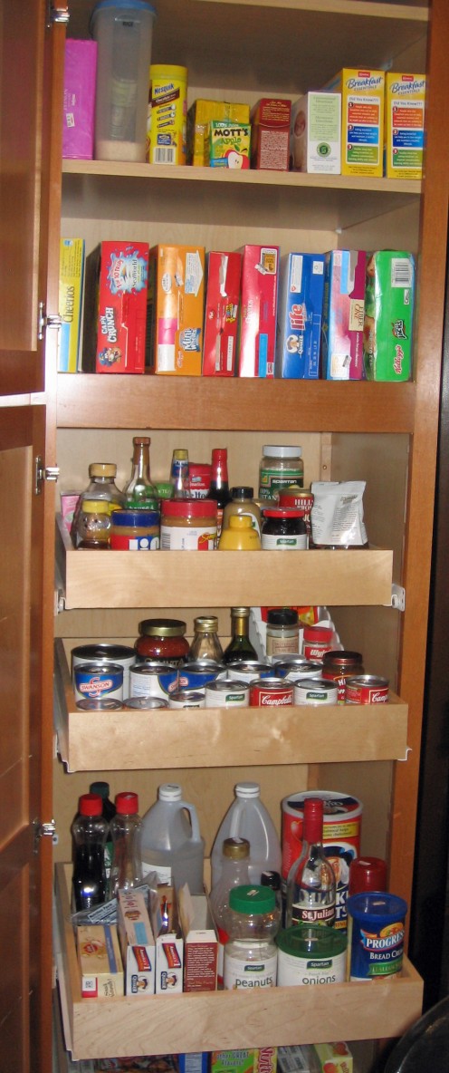 Sliding cabinet shelves in a pantry for easy access.