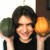 Beautiful Native American Princess brandishing vegetable trophies.