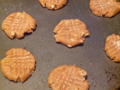 Then take the tines of a fork and flatten your cookies out flat going back and forth to make marks on your cookies like in the photo. 