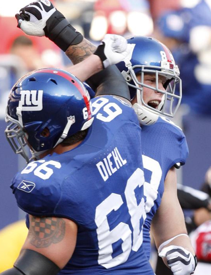 New York Giants offensive tackle David Diehl (66) celebrates with tight end Kevin Boss (89) after Boss scored a touchdown in the second quarter of an NFL football game against the Atlanta Falcons, Sunday, Nov. 22, 2009, in East Rutherford, N.J. (AP P
