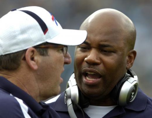 Buffalo Bills interim head coach Perry Fewell, right, talks with an assistant coach during the first quarter of an NFL football game against the Jacksonville Jaguars, Sunday, Nov. 22, 2009, in Jacksonville, Fla. (AP Photo/Stephen Morton)