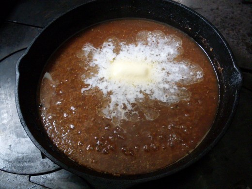 Once the water has been about half absorbed, add butter. Cover and cook several minutes...