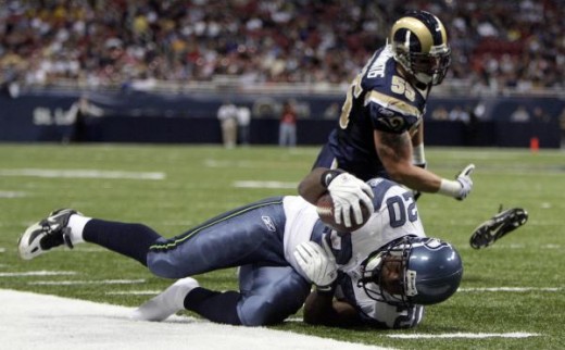 Seattle #20 Justin Forsett  is pushed out of bounds by St. Louis Rams linebacker James Laurinaitis, after running for a 4-yard gain.