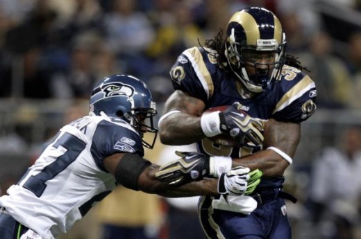 St. Louis Rams running back Steven Jackson, right, runs for a short gain before being brought down by Seattle Seahawks safety Jordan Babineaux during the first quarter  (AP Photo/Jeff Robers)
