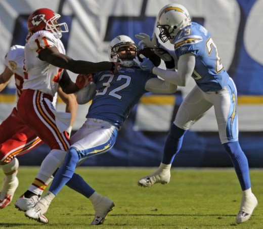 San Diego Chargers' Eric Weddle (32) and Quentin Jammer, right, battle for an interception that Jammer eventually retained as Kansas City Chiefs wide receiver Chris Chambers, left, watches during the first quarter of an NFL football game Sunday, Nov.